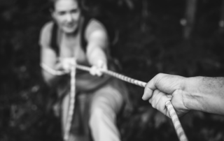 High-Conflict-Divorce, black and white image of woman pulling rope playing tug of war