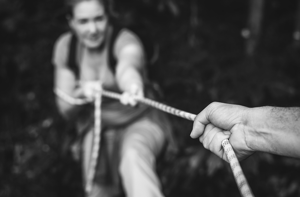 High-Conflict-Divorce, black and white image of woman pulling rope playing tug of war